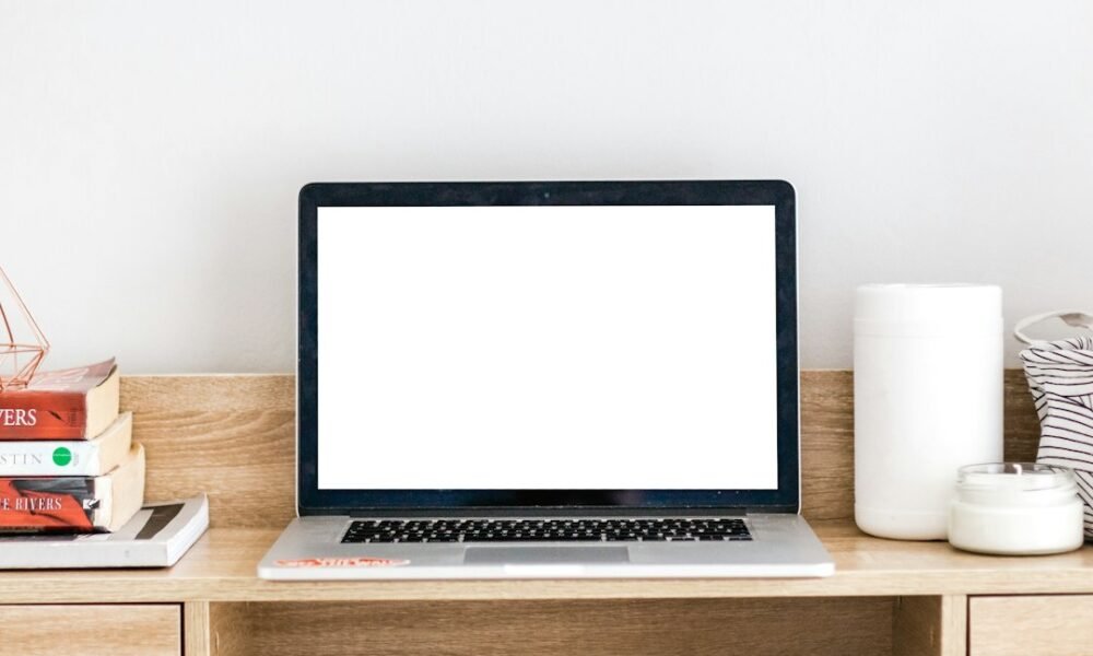 Open laptop on a desk with the screen turned on