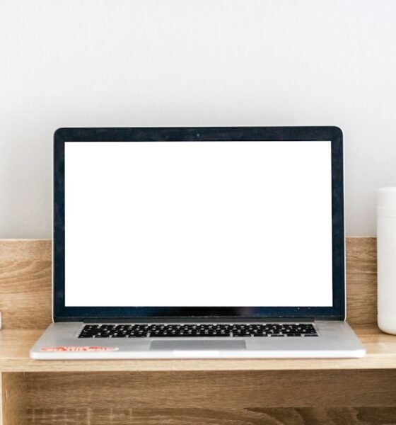 Open laptop on a desk with the screen turned on