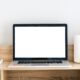 Open laptop on a desk with the screen turned on