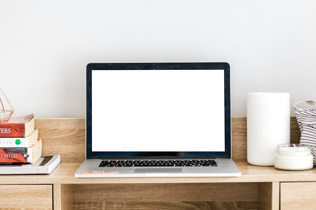 Open laptop on a desk with the screen turned on