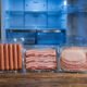 Illustration of packaged hot dogs and deli meats for a recall notice
